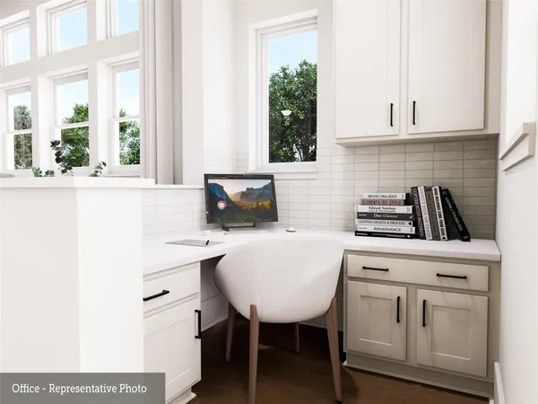 a kitchen with white cabinets and a stove