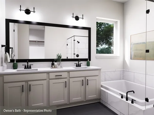 a bathroom with a tub a sink and mirror