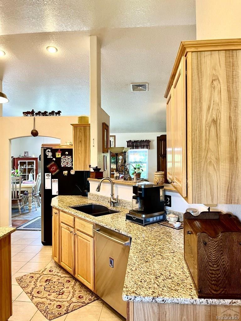 6053 Muddy Creek Road Pueblo, CO 81004 - Photo 17 of 50 a living room with stainless steel appliances kitchen island granite countertop furniture and a large window