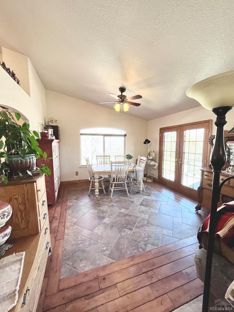 6053 Muddy Creek Road Pueblo, CO 81004 - Photo 20 of 50 a view of a dining room with furniture a chandelier and wooden floor