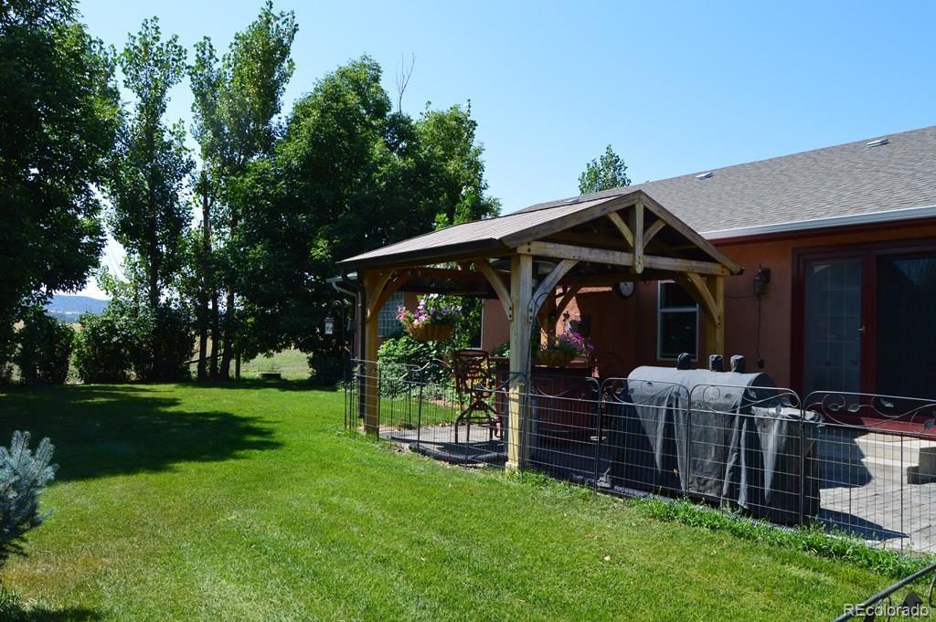 6053 Muddy Creek Road Pueblo, CO 81004 - Photo 40 of 50 a view of a chair and tables in the garden