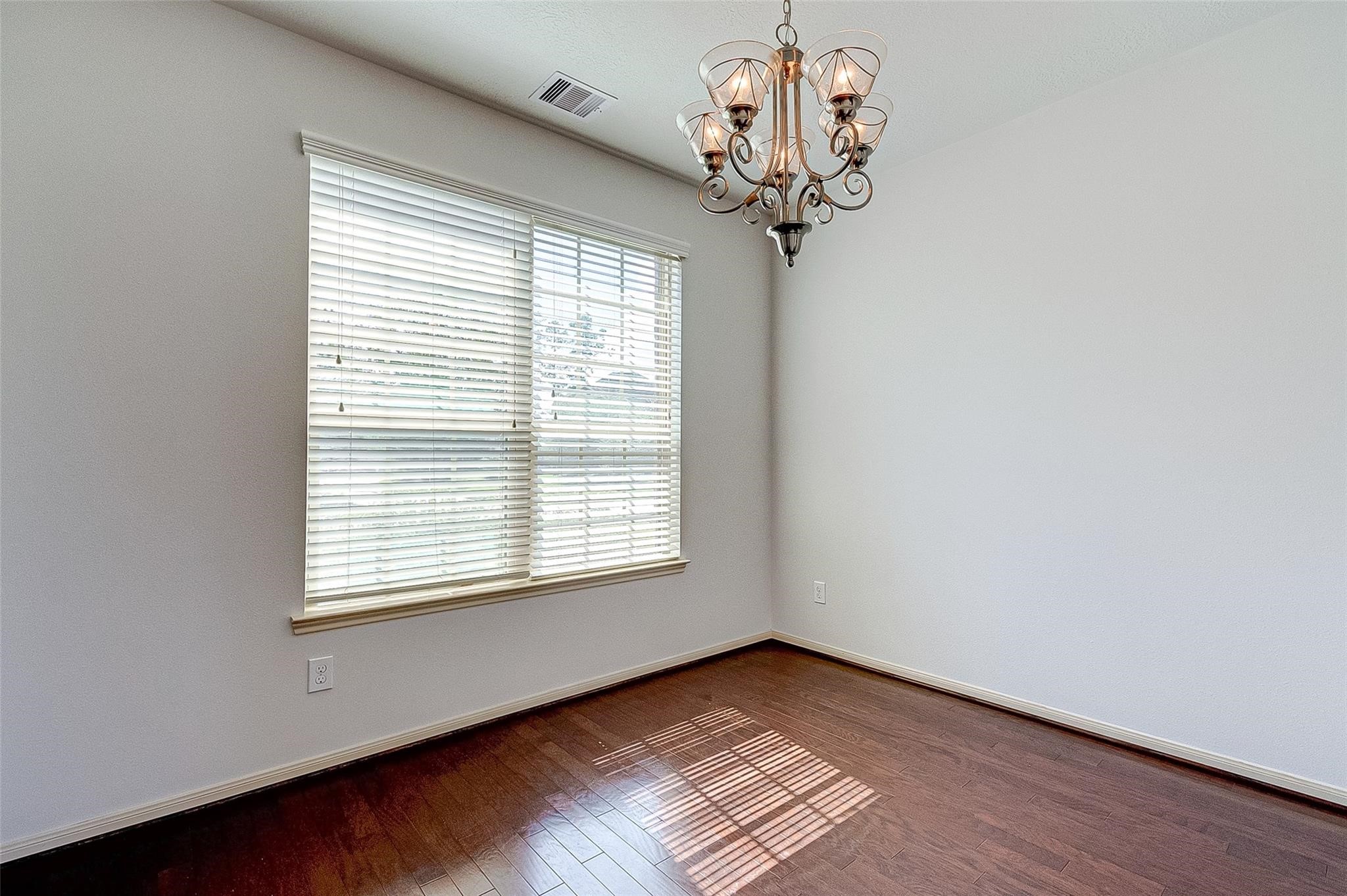 79 West Lasting Spring Circle Spring, TX 77389 - Photo 11 of 48 a view of an empty room with wooden floor and a window