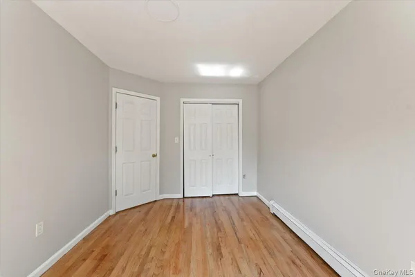 a view of a room with wooden floor and white walls
