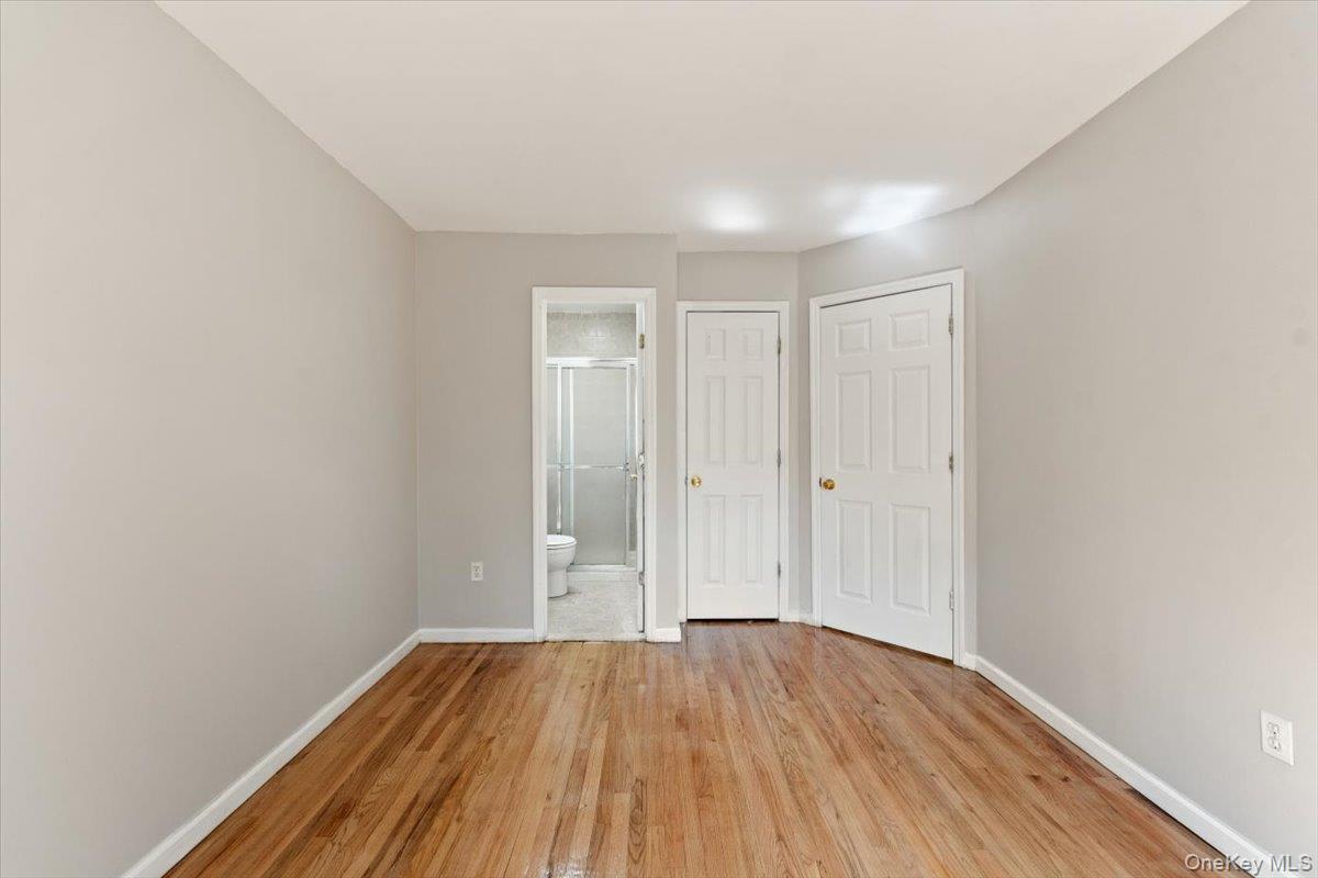 1309 Vreeland Avenue, Unit 3 Bronx, NY 10461 - Photo 13 of 13 Unfurnished bedroom featuring light wood finished floors and ensuite bathroom