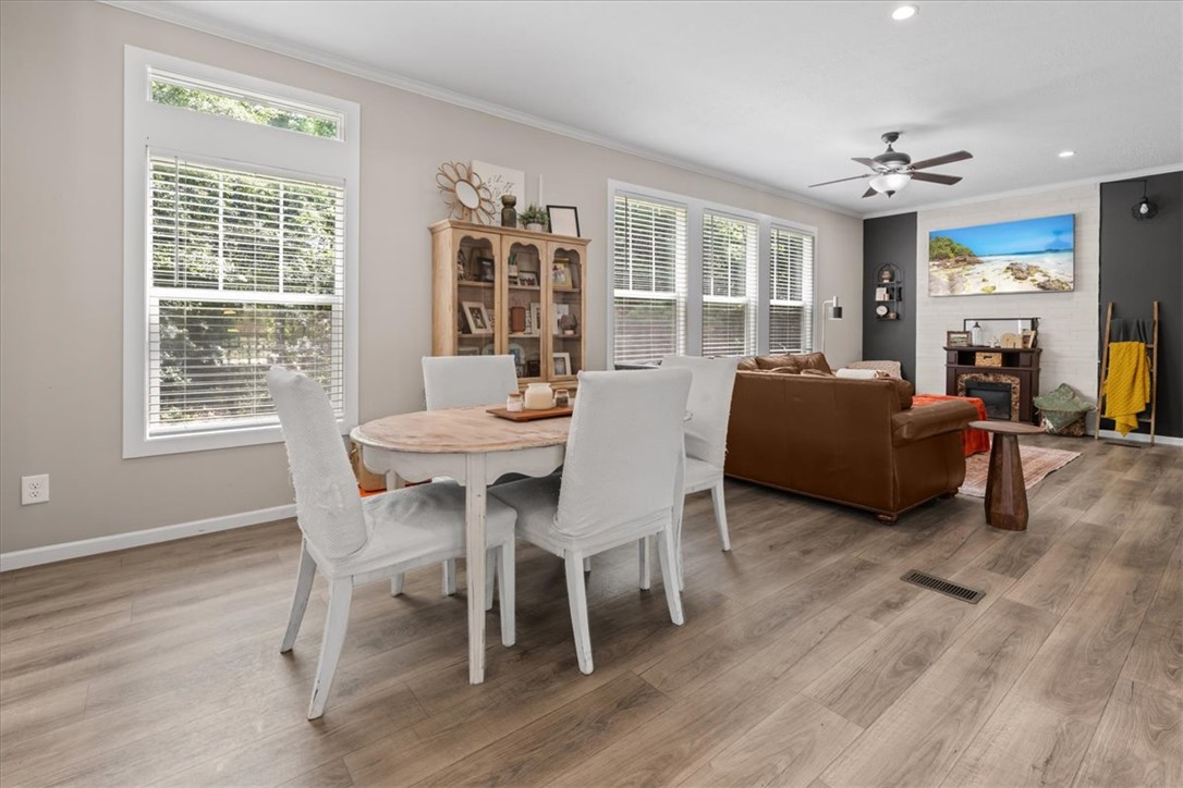 116 Parkview Road Iva, SC 29655 - Photo 6 of 44 Warm wood-tone flooring connects this inviting dining area to a spacious, comfortable living space.
