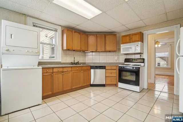 a kitchen with a stove a sink and a refrigerator