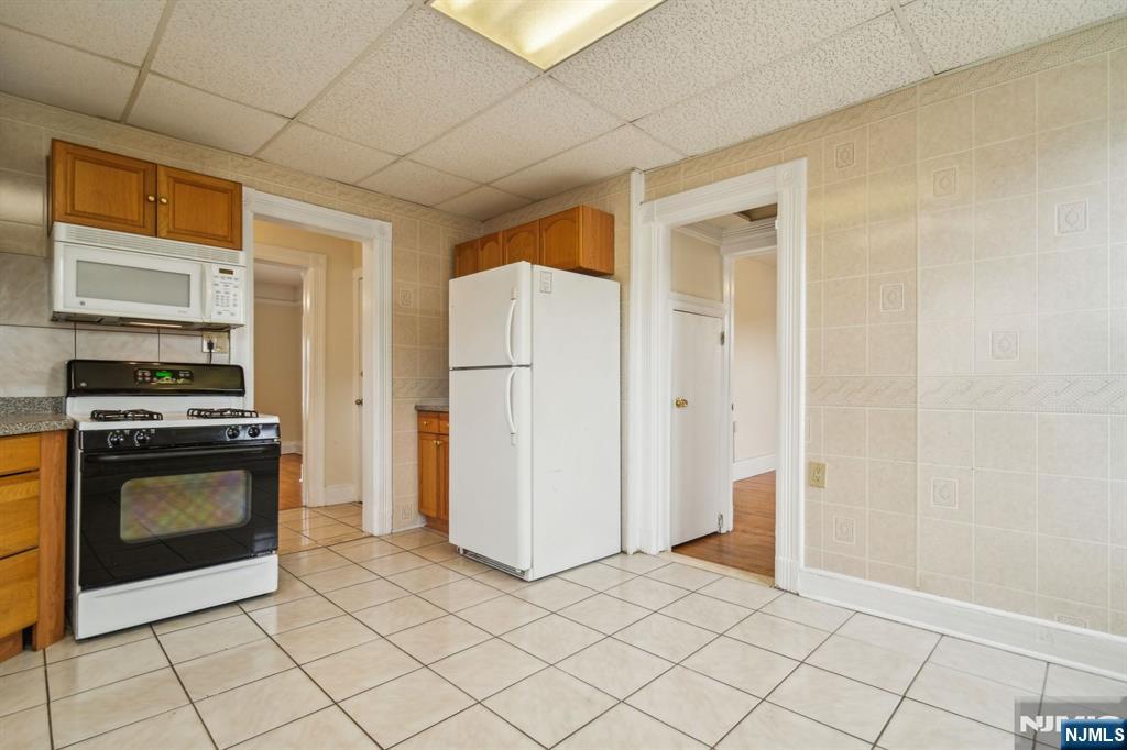 44 Elm Street, Unit 2 Montclair, NJ 07042 - Photo 15 of 33 a kitchen with white cabinets and stainless steel appliances