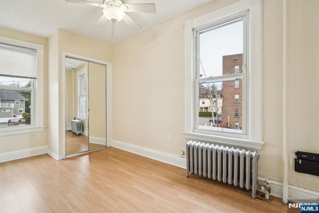 44 Elm Street, Unit 2 Montclair, NJ 07042 - Photo 18 of 33 an empty room with wooden floor fan and windows