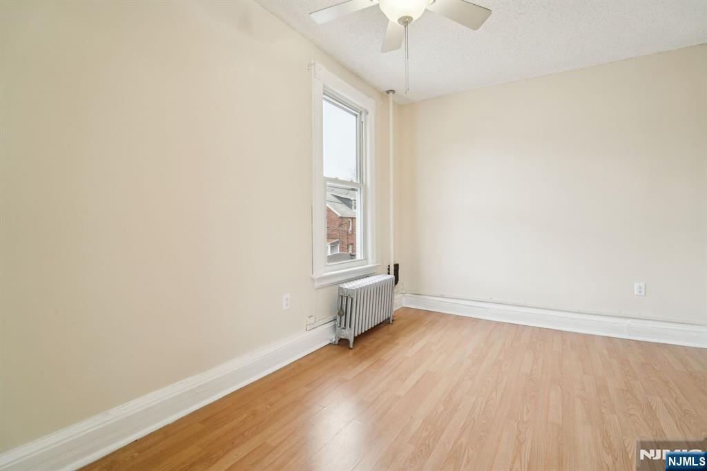44 Elm Street, Unit 2 Montclair, NJ 07042 - Photo 20 of 33 an empty room with wooden floor and windows