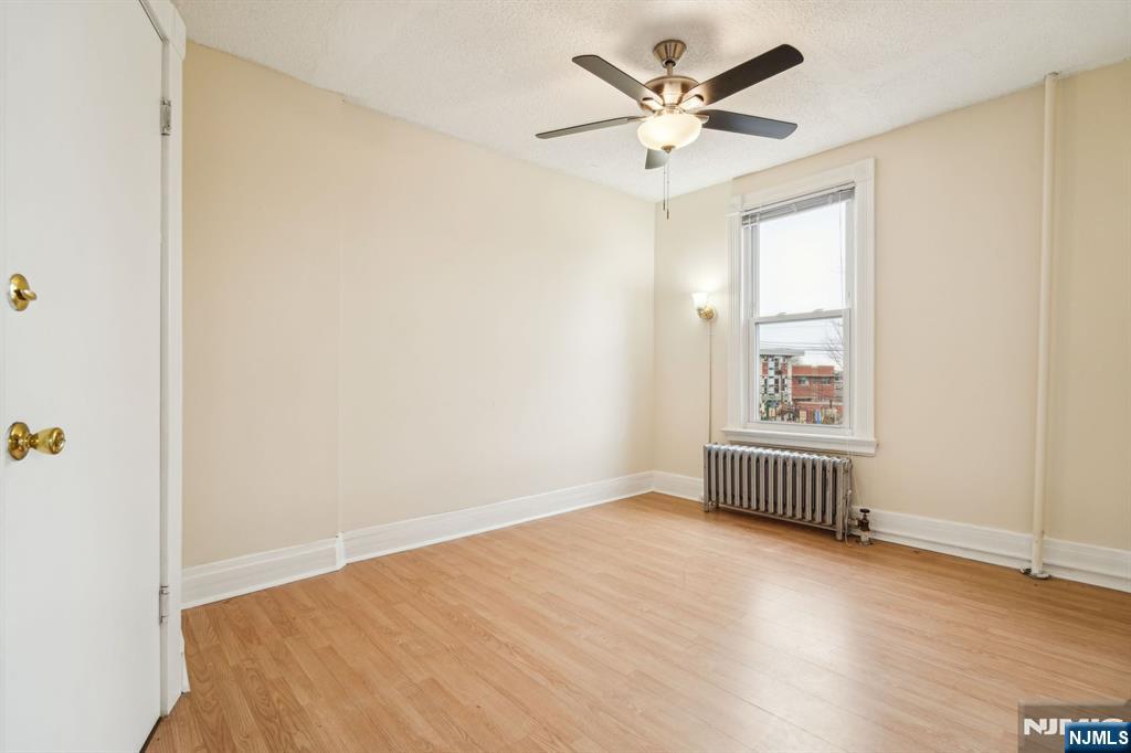 44 Elm Street, Unit 2 Montclair, NJ 07042 - Photo 28 of 33 an empty room with a window and a ceiling fan