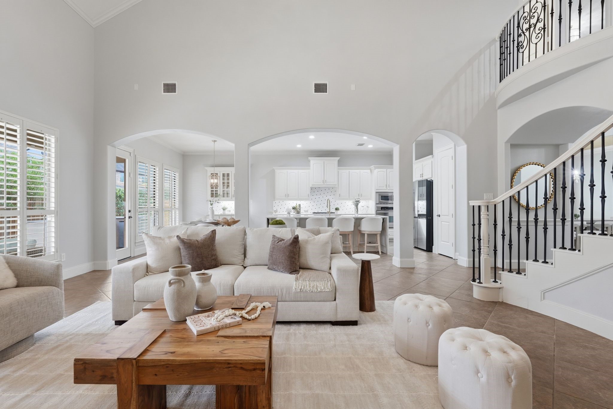 7603 Hogan Bridge Court Spring, TX 77389 - Photo 10 of 50 A stunning living space anchored by a wrought iron staircase and upper-level railing, all flowing effortlessly toward the kitchen.