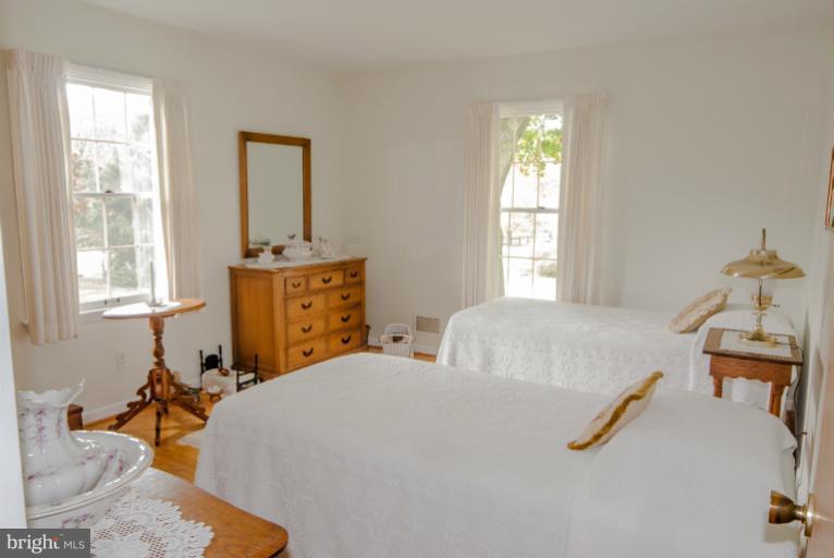 4013 Chatham Road Ellicott City, MD 21042 - Photo 5 of 20 a bedroom with a bed and wooden floor