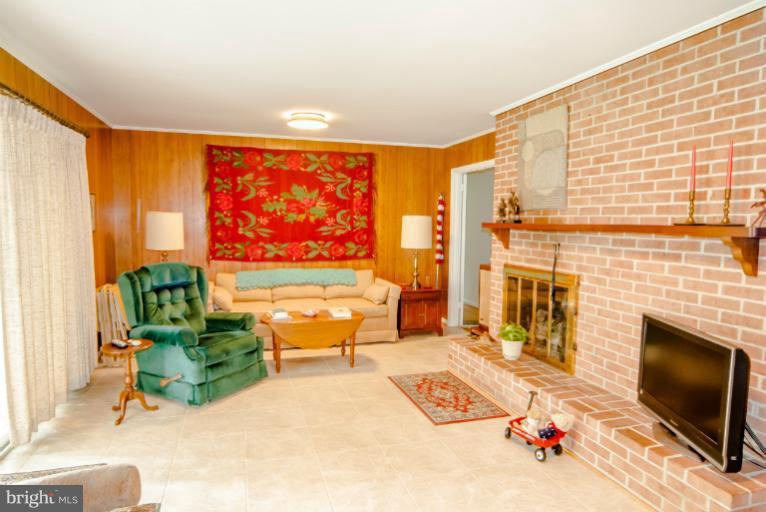 4013 Chatham Road Ellicott City, MD 21042 - Photo 6 of 20 a living room with fireplace furniture and a flat screen tv