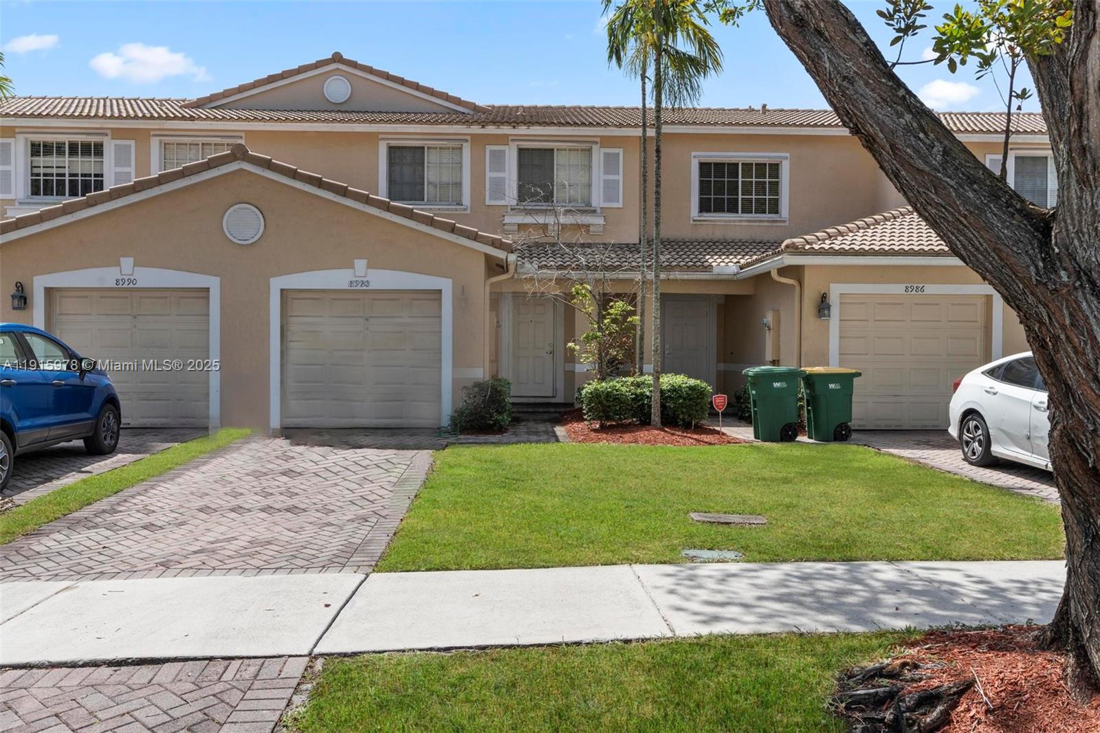 8988 Chambers Street, Unit 8988 Tamarac, FL 33321 - Photo 2 of 8 a front view of a house with a garden and yard