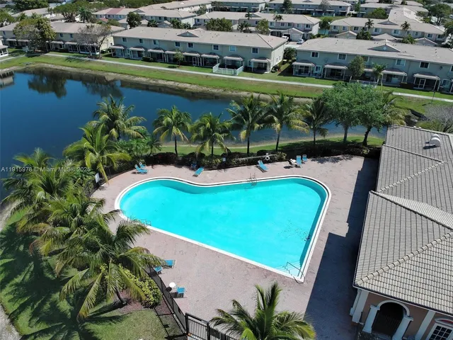 a view of a swimming pool with a patio and a garden