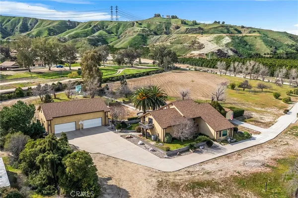 an aerial view of a house with yard swimming pool and outdoor seating