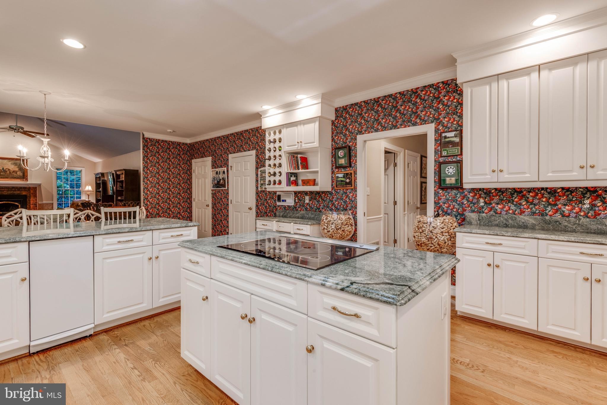 14418 Katie Road Phoenix, MD 21131 - Photo 15 of 29 a kitchen with granite countertop cabinets stainless steel appliances and wooden floor