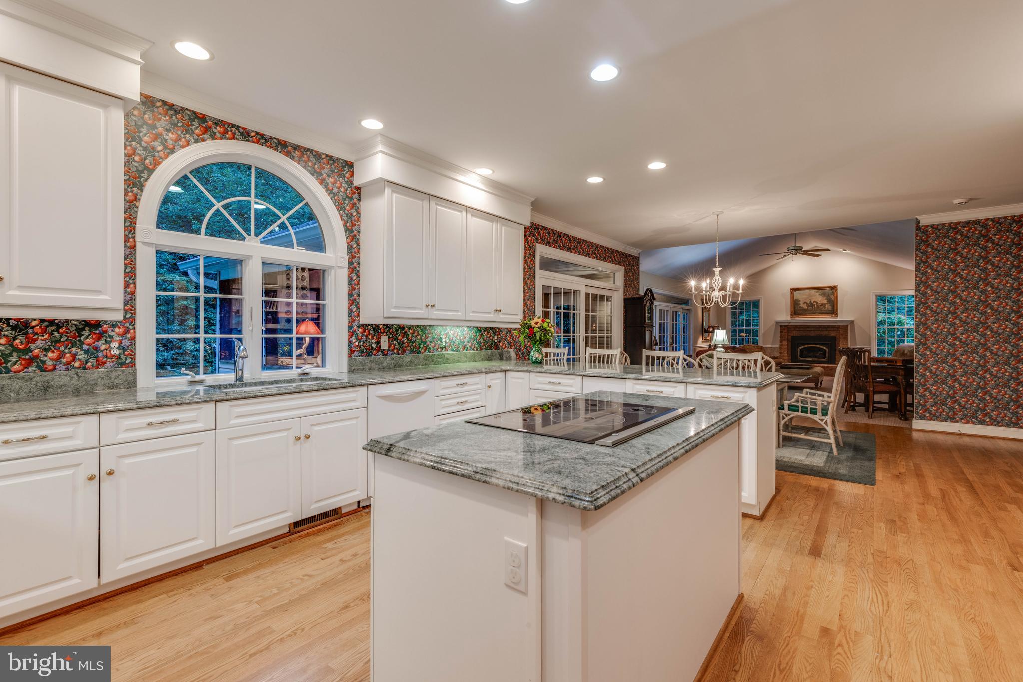 14418 Katie Road Phoenix, MD 21131 - Photo 4 of 29 a kitchen with stainless steel appliances granite countertop a sink stove and wooden floor