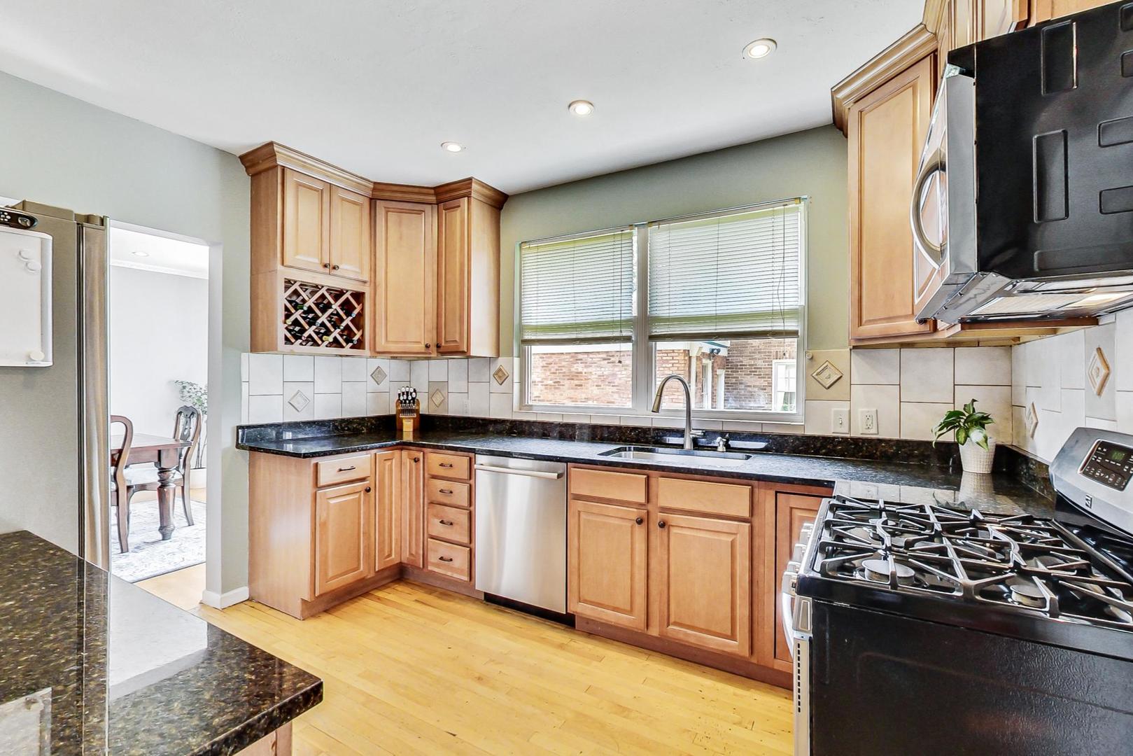 518 South Arlington Heights Road Arlington Heights, IL 60005 - Photo 11 of 42 a kitchen with stainless steel appliances granite countertop a stove a sink and a microwave