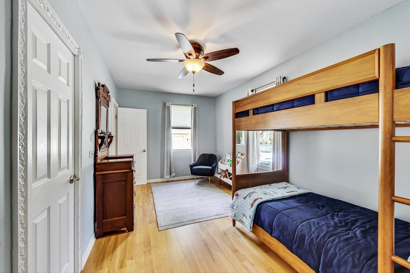 518 South Arlington Heights Road Arlington Heights, IL 60005 - Photo 16 of 42 a bedroom with a bed and a chandelier