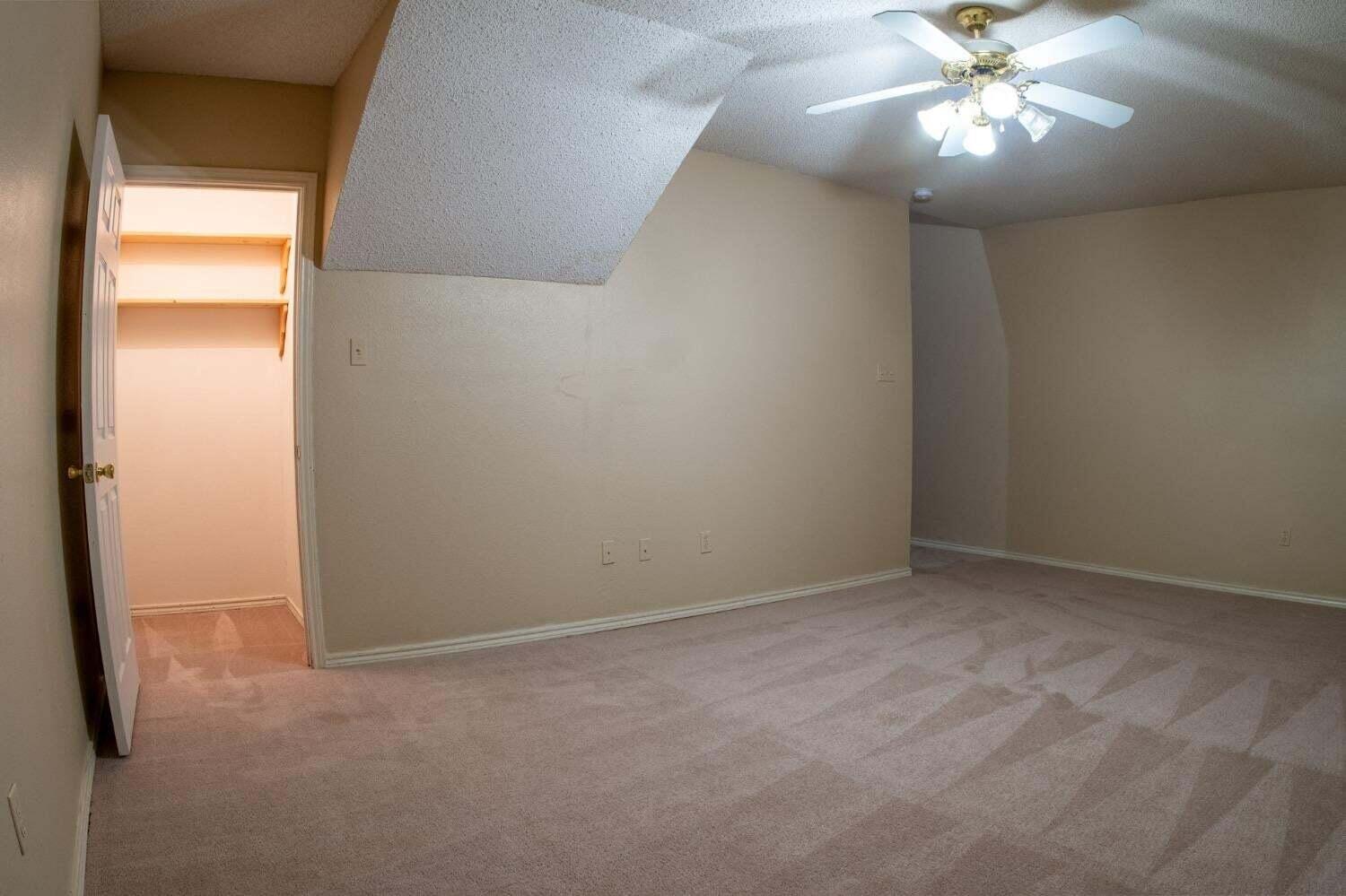 3409 97th Street Lubbock, TX 79423 - Photo 11 of 21 an empty room with a window and a fan
