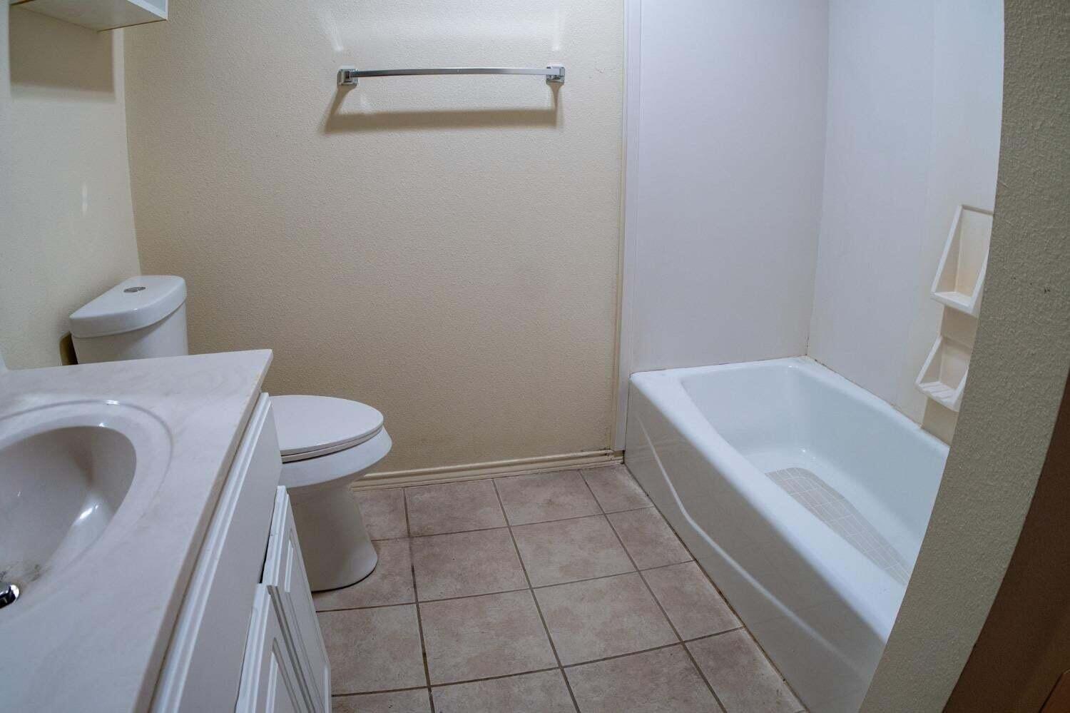 3409 97th Street Lubbock, TX 79423 - Photo 15 of 21 a bathroom with a sink and toilet