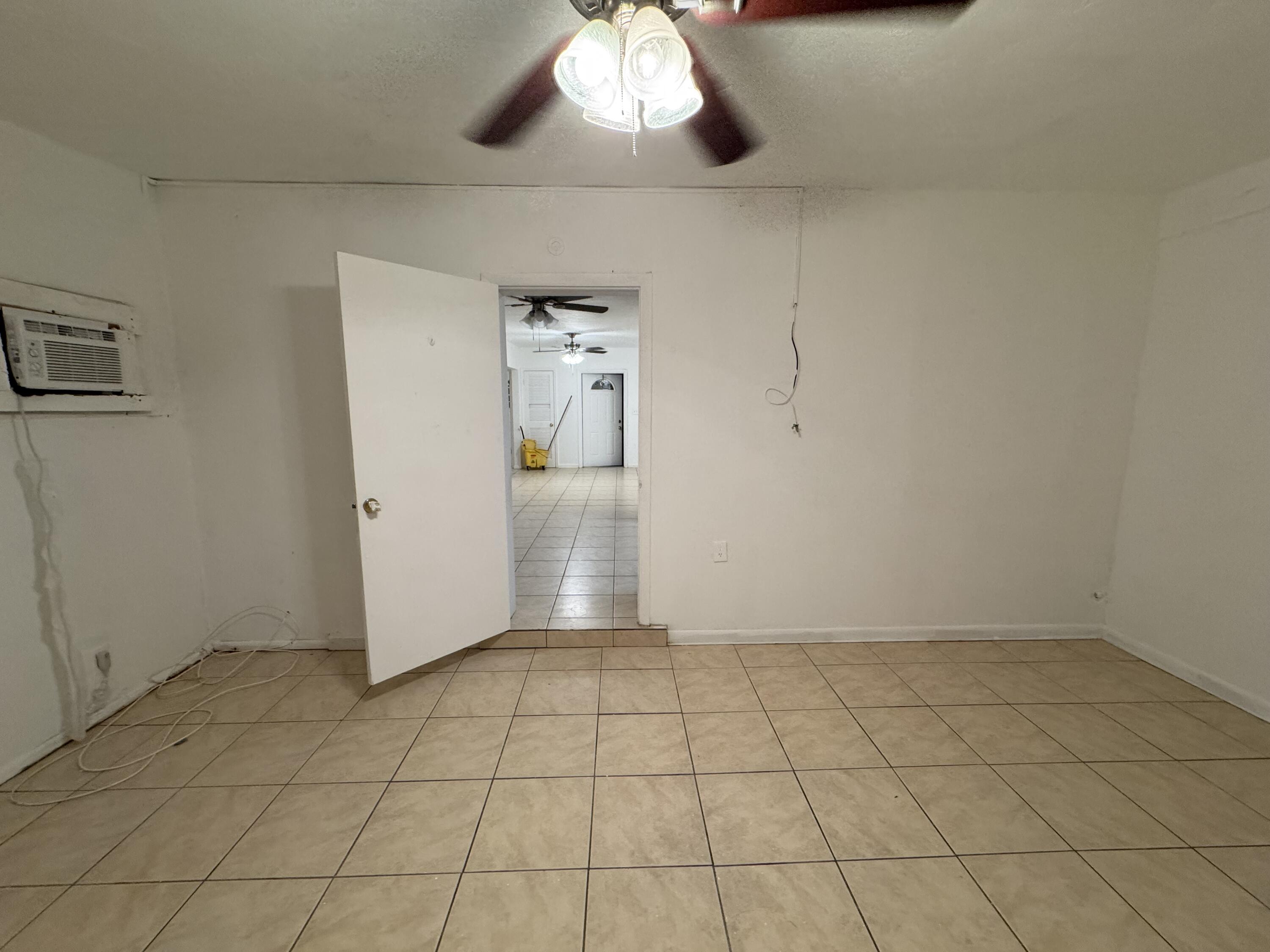 198 Southwest 15th Street Boca Raton, FL 33432 - Photo 6 of 11 an empty room with a chandelier fan