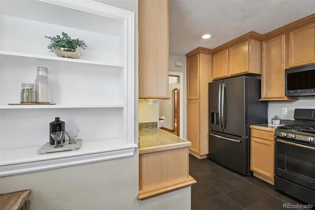 a kitchen with stainless steel appliances a refrigerator and a stove top oven