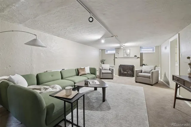 a living room with furniture and a fireplace