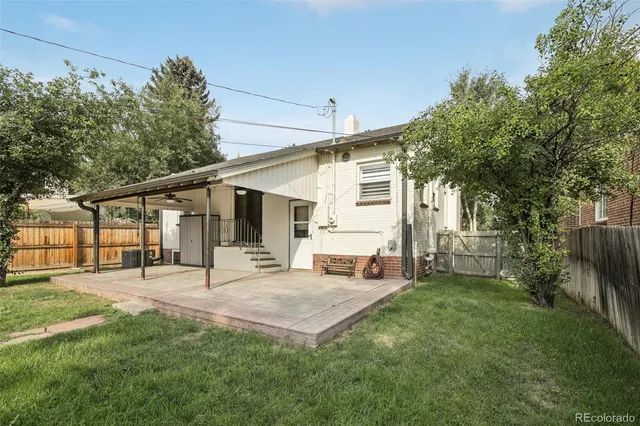 a white house that has tree in front of it
