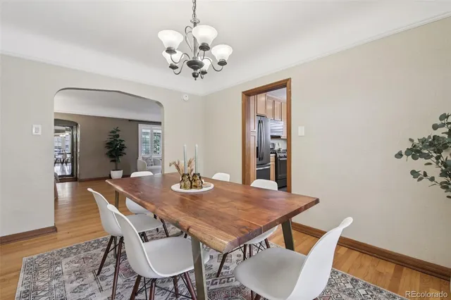 a view of a dining room with furniture and chandelier