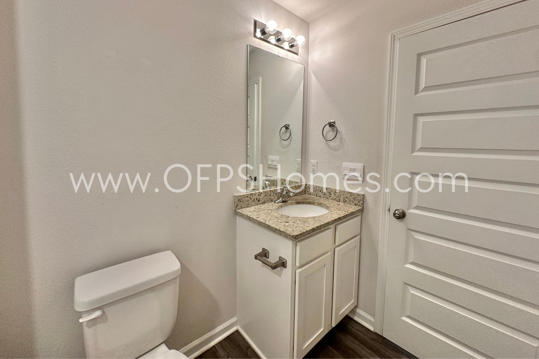 853 Otto Loop Crestview, FL 32539 - Photo 8 of 36 a bathroom with a sink a toilet and a mirror