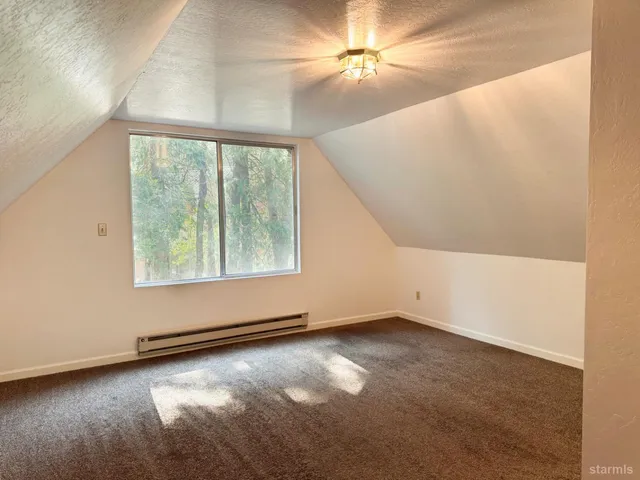 an empty room with windows and ceiling fan