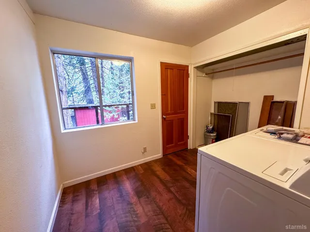 a room with wooden floor and a window
