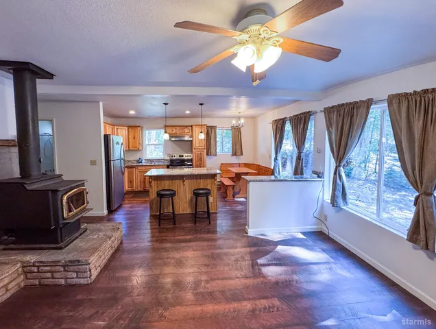 a living room with fireplace furniture and a wooden floor
