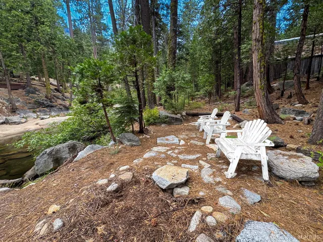 a view of a table and chairs in the backyard