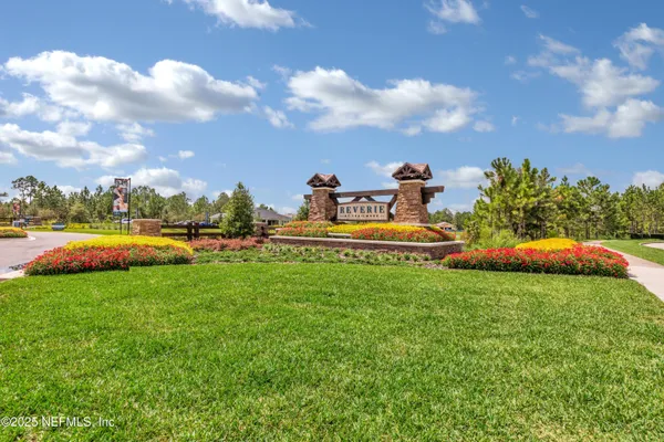a front view of a house with garden and houses