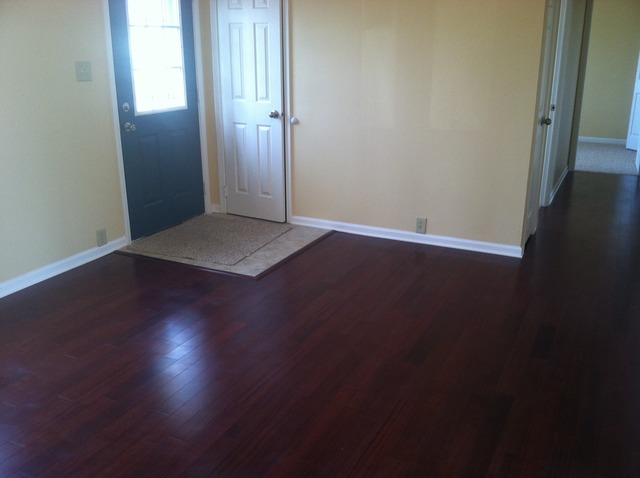 309 Tallman Avenue Romeoville, IL 60446 - Photo 2 of 16 an empty room with wooden floor and windows