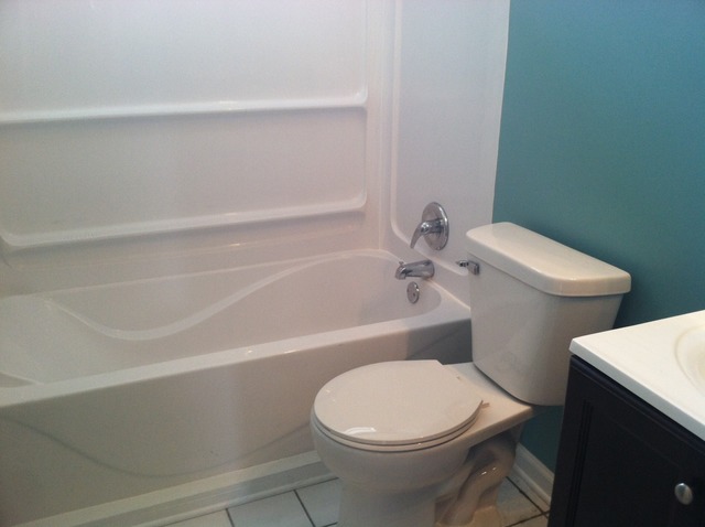309 Tallman Avenue Romeoville, IL 60446 - Photo 12 of 16 a white toilet and tub sitting next to a bathroom sink