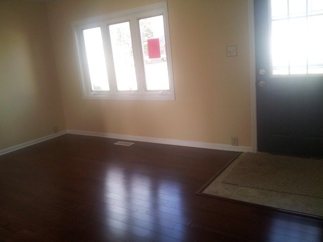 309 Tallman Avenue Romeoville, IL 60446 - Photo 3 of 16 an empty room with wooden floor and windows