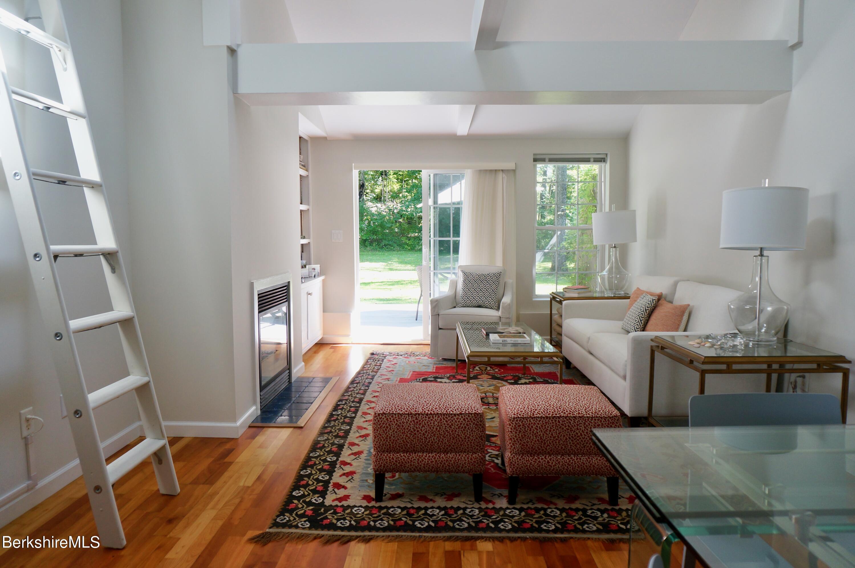72 Interlaken Road, Unit 1 West Stockbridge, MA 01266 - Photo 1 of 16 a living room with furniture and a fireplace
