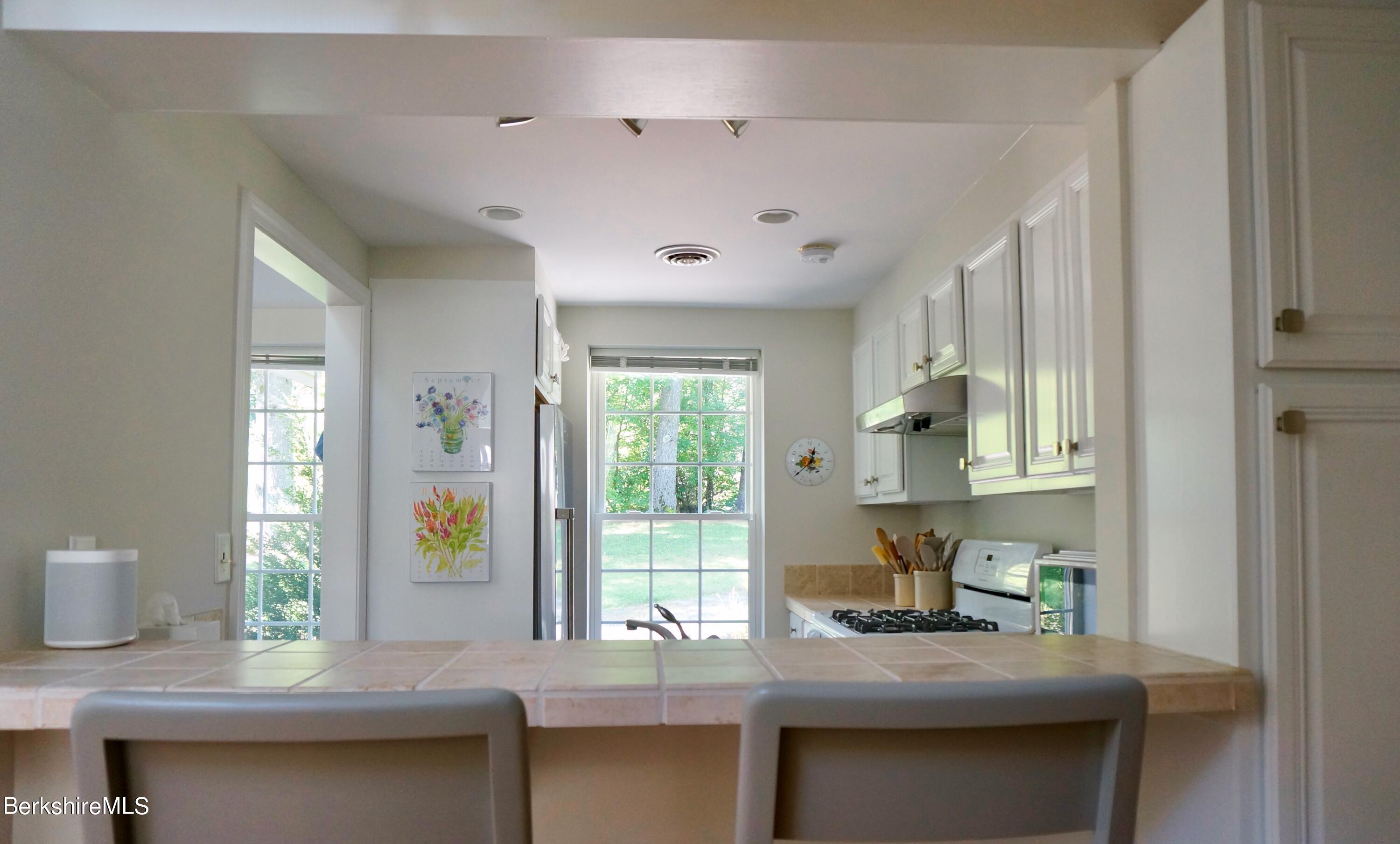 72 Interlaken Road, Unit 1 West Stockbridge, MA 01266 - Photo 7 of 16 a kitchen with granite countertop a sink cabinets and window