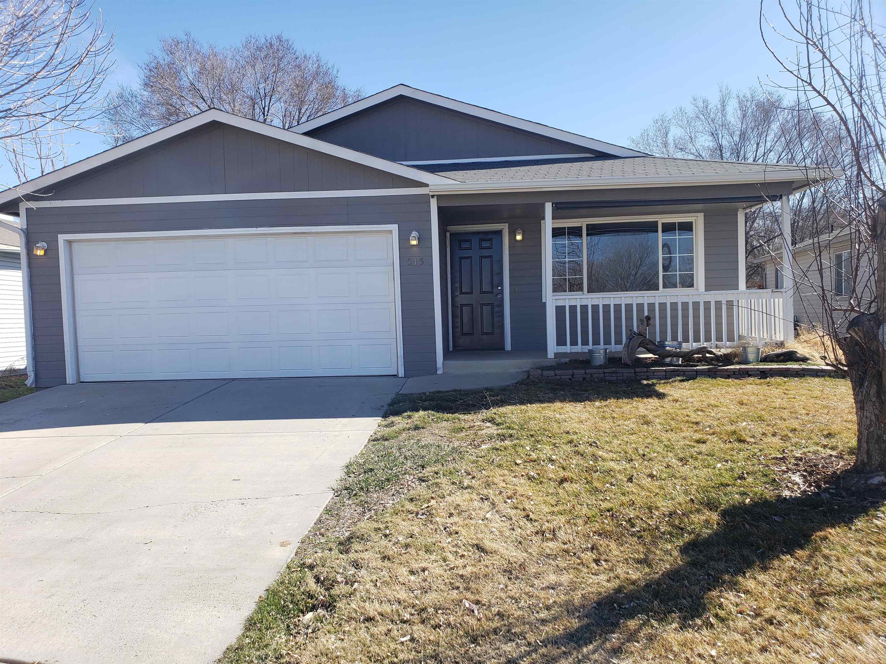 515 Quebec Court Fruita, CO 81521 - Photo 1 of 16 a front view of a house with a yard