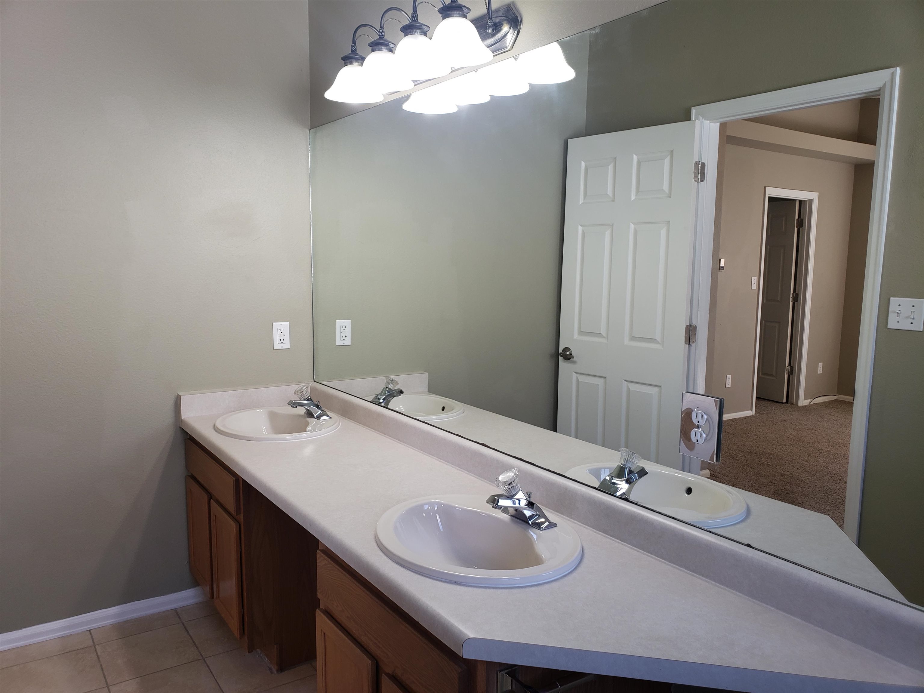 515 Quebec Court Fruita, CO 81521 - Photo 12 of 16 a bathroom with a sink and a mirror with window