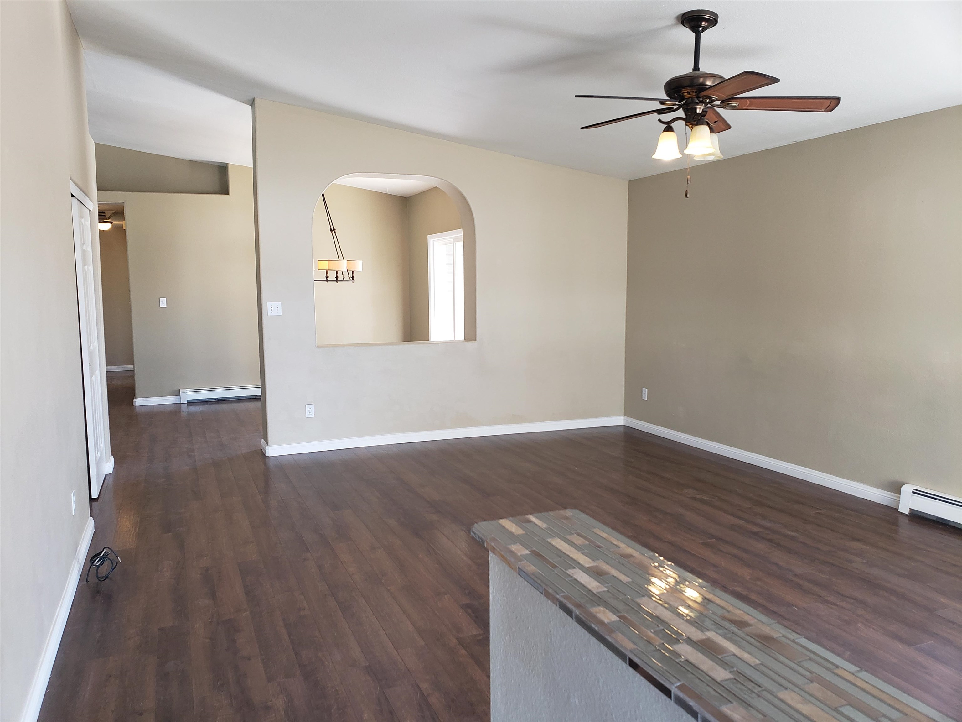 515 Quebec Court Fruita, CO 81521 - Photo 2 of 16 wooden floor in an empty room with a window