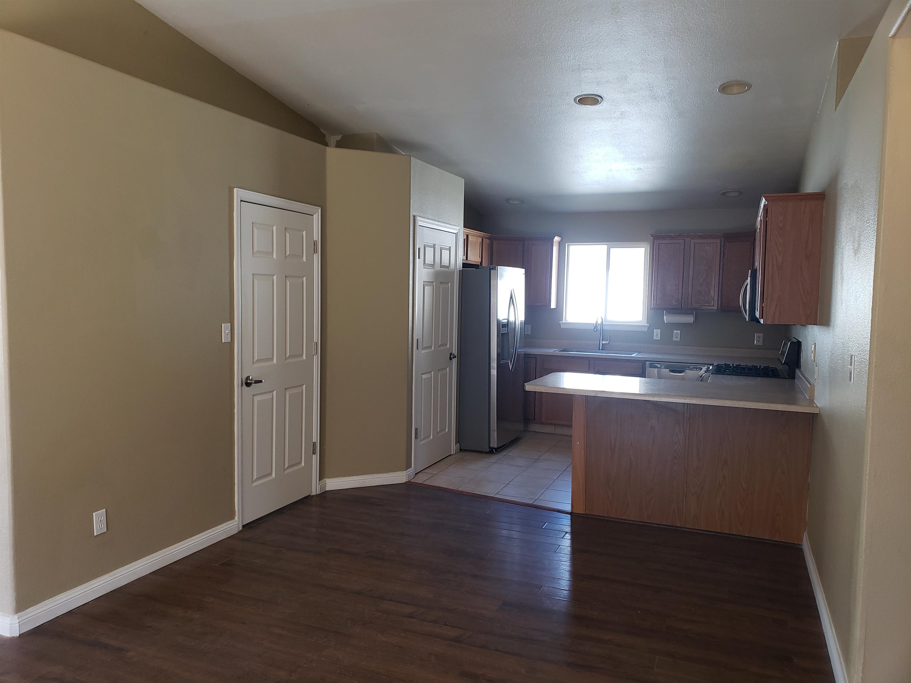 515 Quebec Court Fruita, CO 81521 - Photo 5 of 16 a view of a kitchen with a sink and a refrigerator