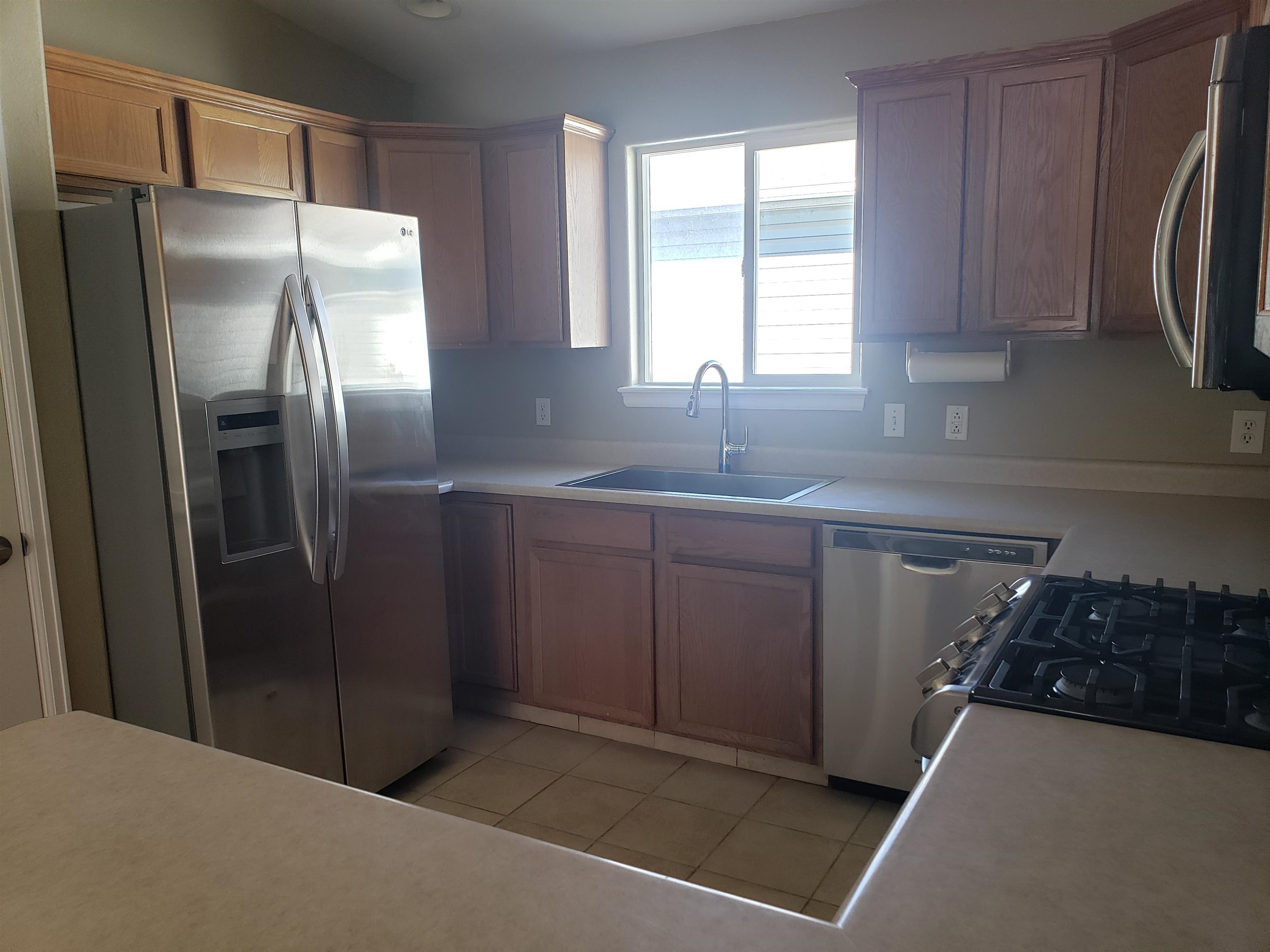 515 Quebec Court Fruita, CO 81521 - Photo 7 of 16 a kitchen with stainless steel appliances granite countertop a refrigerator and a sink
