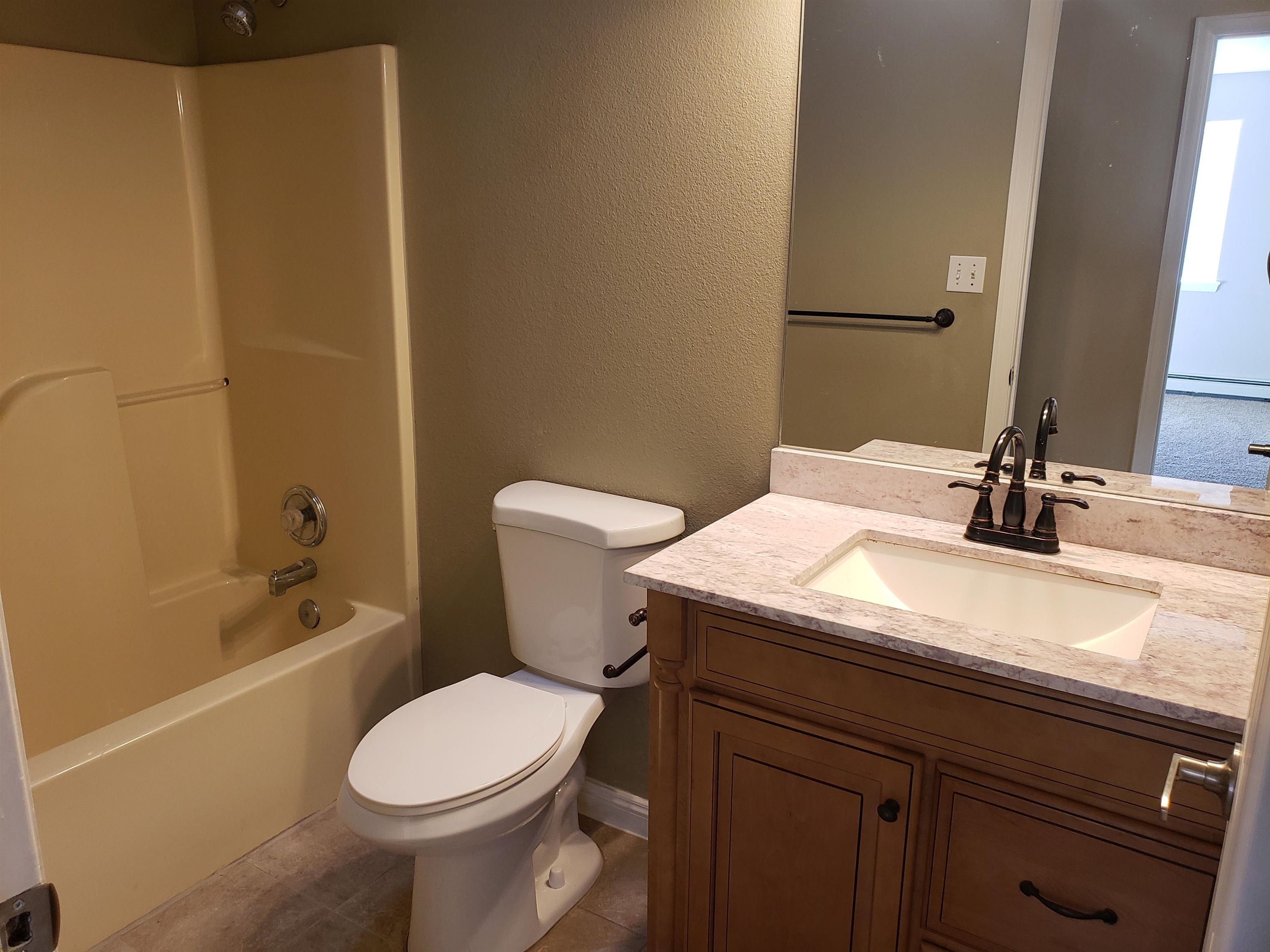 515 Quebec Court Fruita, CO 81521 - Photo 8 of 16 a bathroom with a sink a toilet and shower