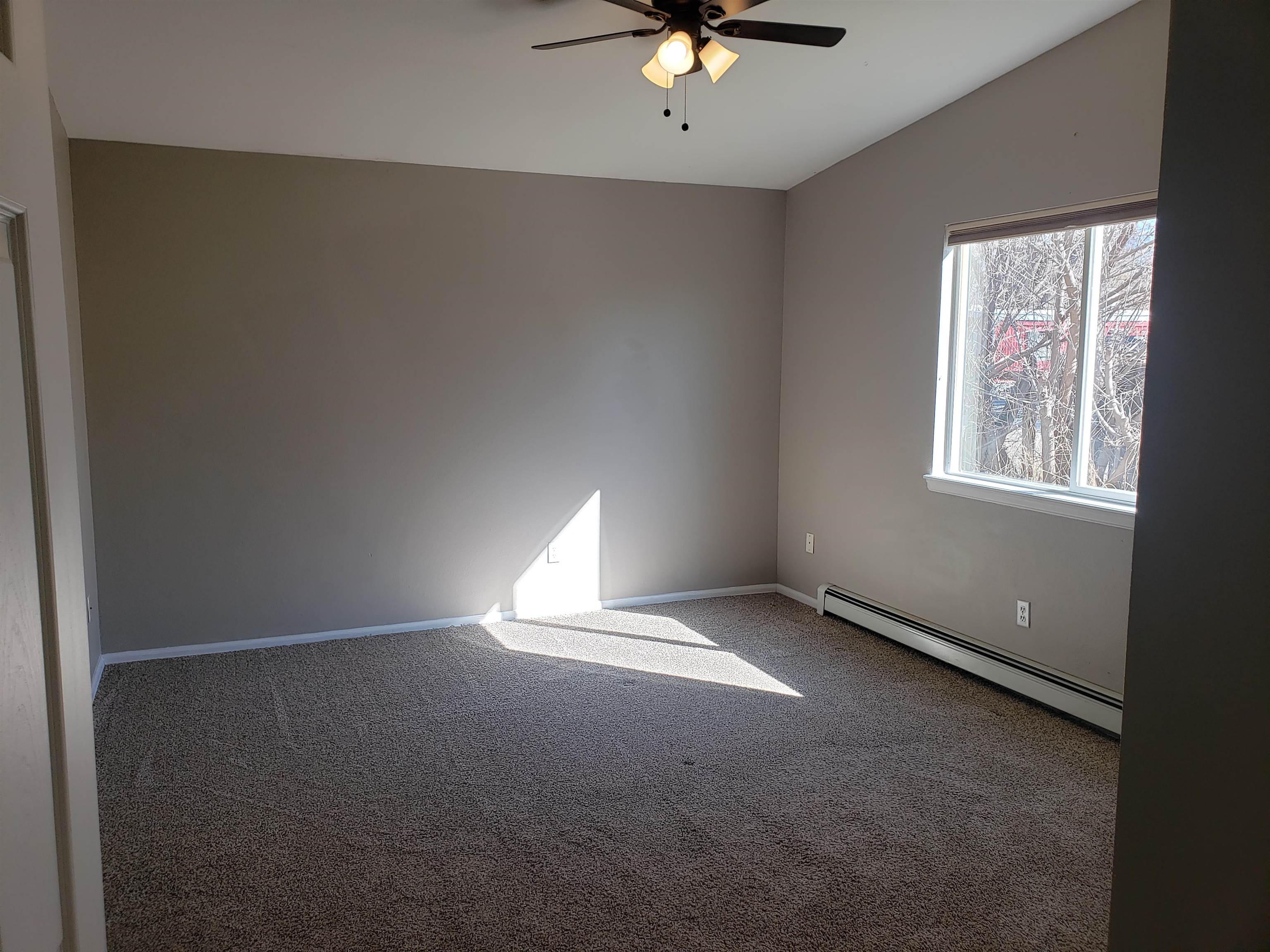 515 Quebec Court Fruita, CO 81521 - Photo 9 of 16 an empty room with windows