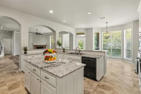 a kitchen with a sink stove and cabinets